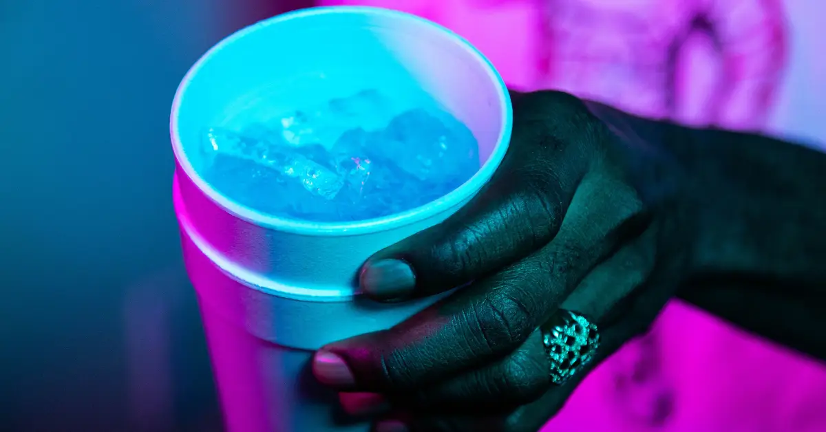 A hand holding a double stacked styrofoam cup