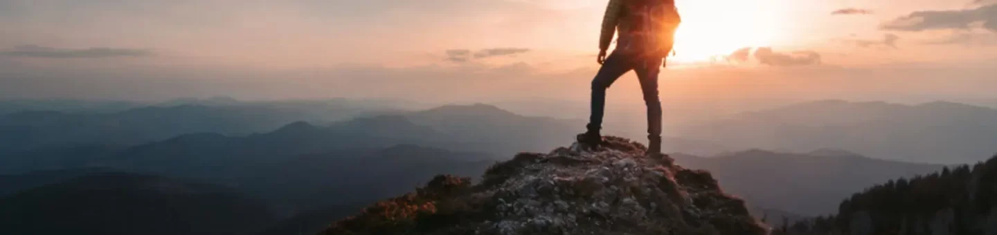 Inspiring picture of a person summiting a mountain top